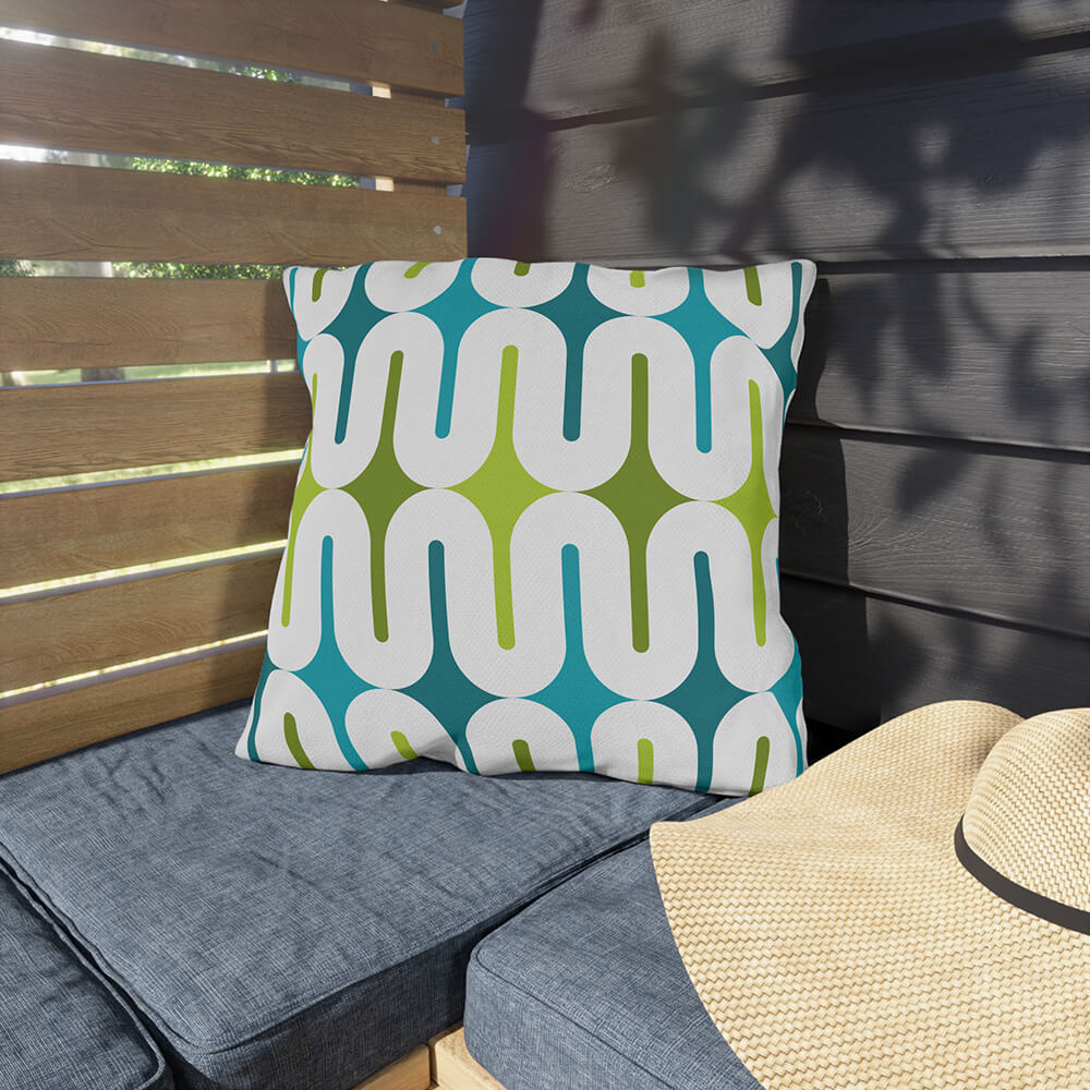 Mid Century Modern Aqua Green Galaxie 18" Outdoor Pillow on a bench