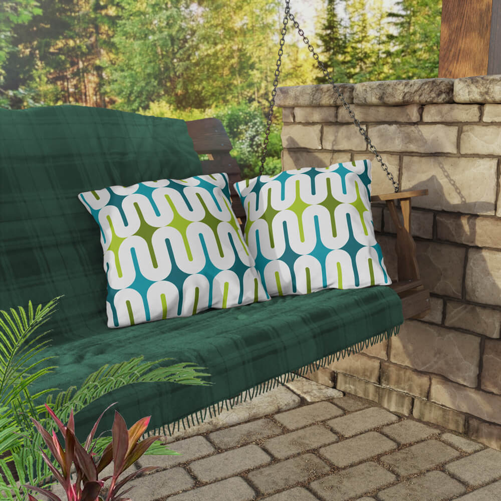 Two Mid Century Modern Aqua Green Galaxie 18" Outdoor Pillow on a swing bench