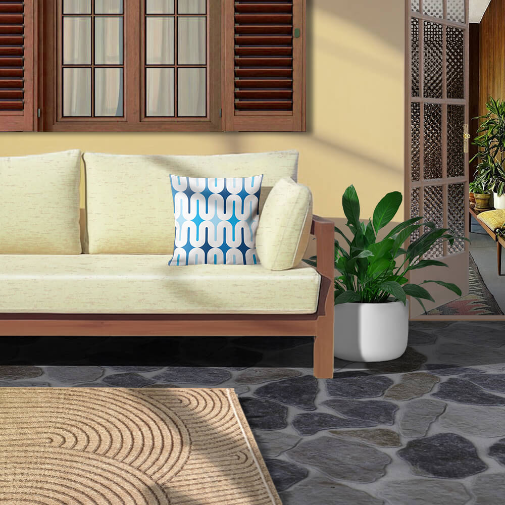 Mid Century Modern Blue Galaxie 18" Outdoor Pillow on a patio sofa