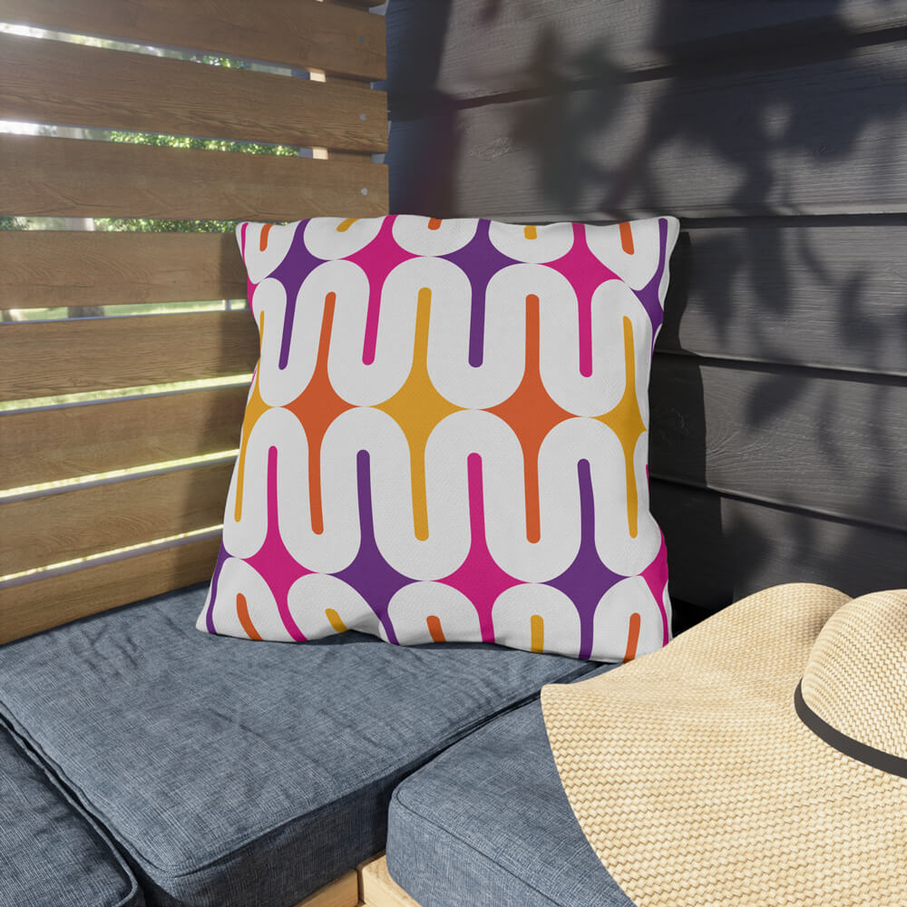 Mid Century Modern Orange Purple Galaxie 18" Outdoor Pillow on a bench