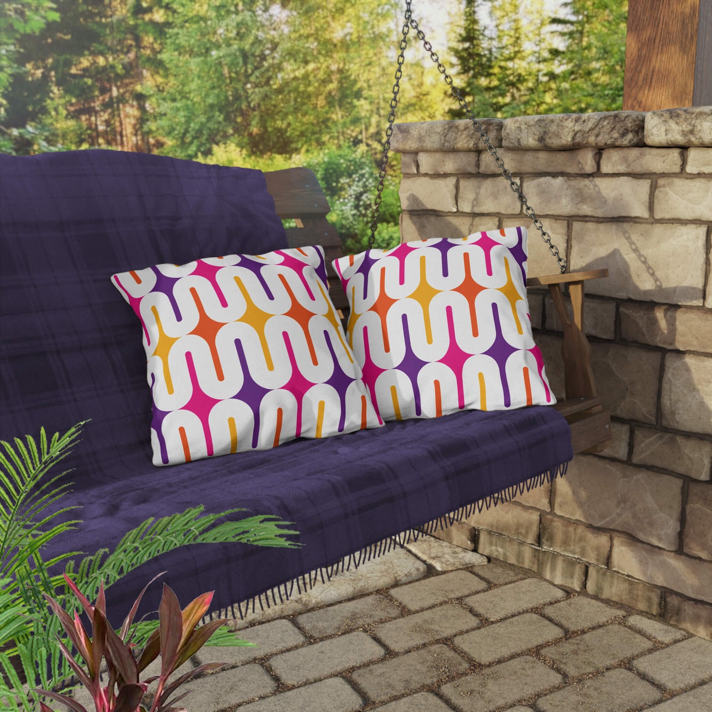 Mid Century Modern Orange Purple Galaxie 18" Outdoor Pillow on a swing bench