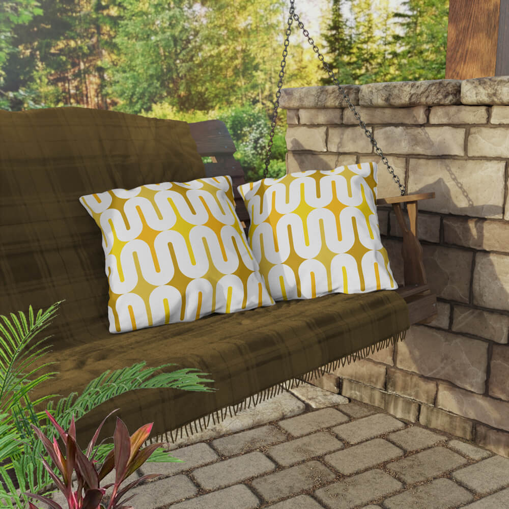 Two Mid Century Modern Yellow Galaxie 18" Outdoor Pillow on a swing bench