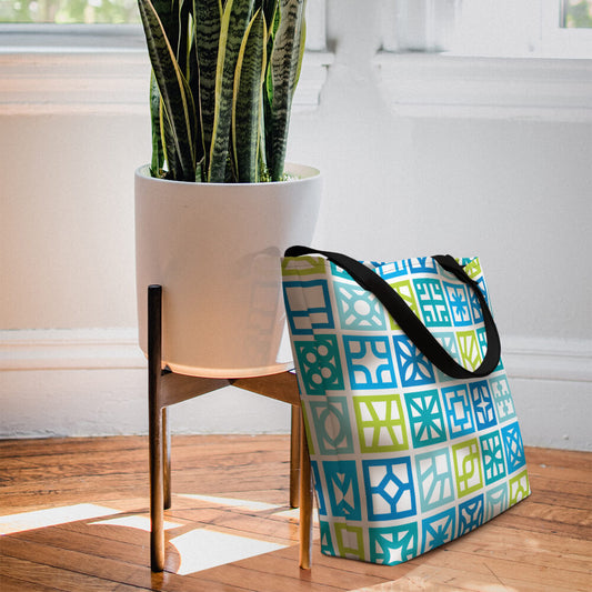 Mid Century Modern Blue Breeze Blocks Beach Bag besides a snake plant