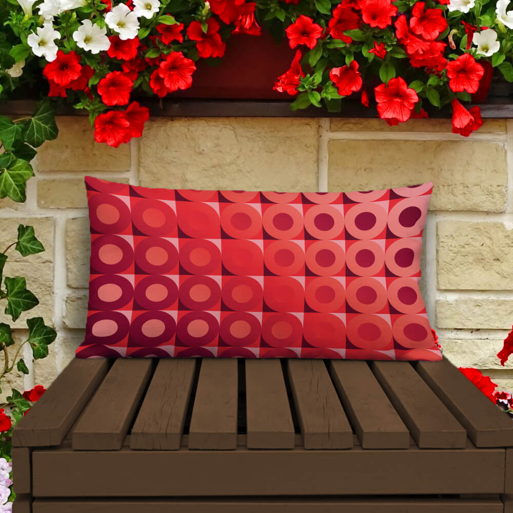 Mid Century Modern Coral Red LifeSavers 20" x 12" Rectangular Throw Pillow on a patio bench