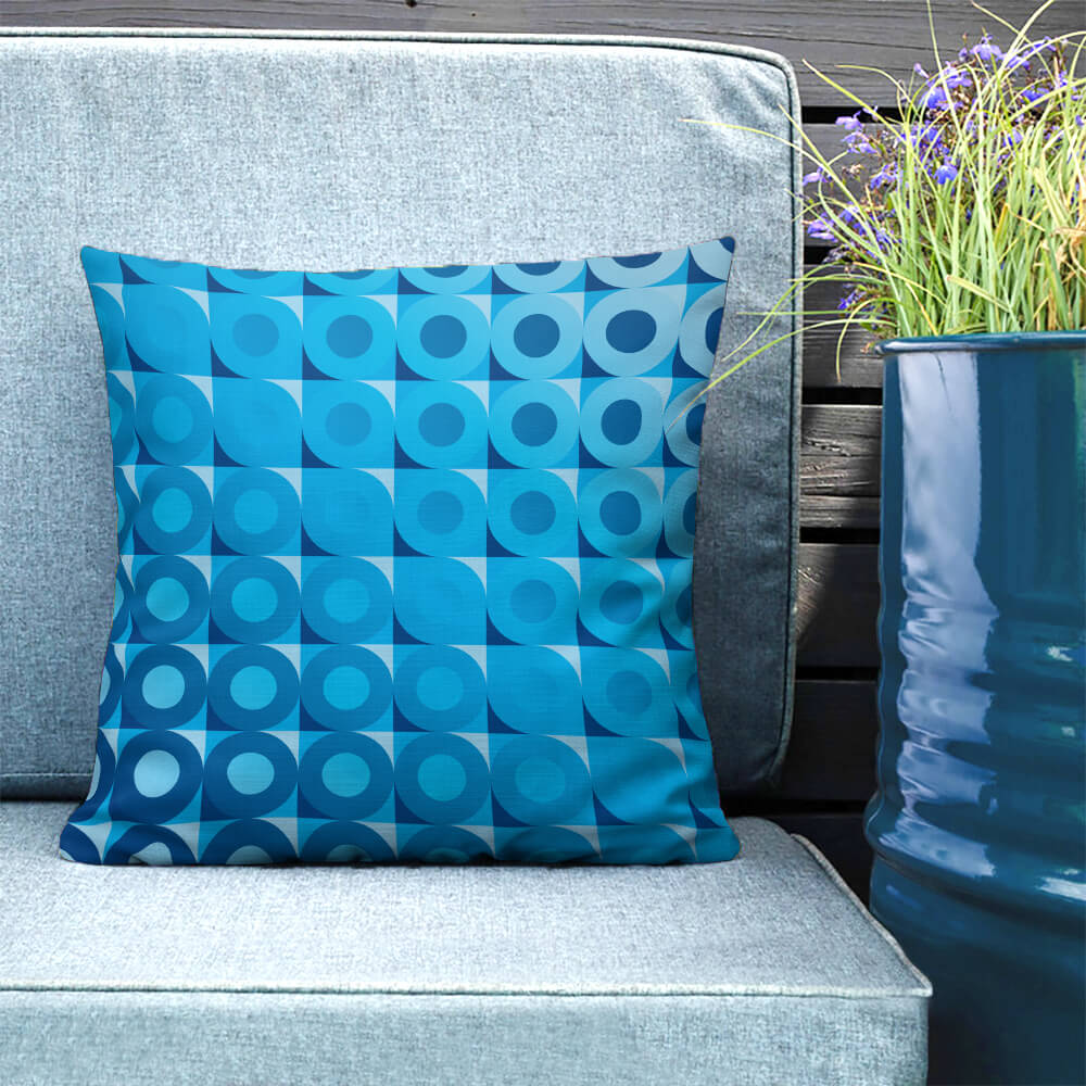 Mid Century Modern Blue LifeSavers 18" Square Throw Pillow on a patio bench