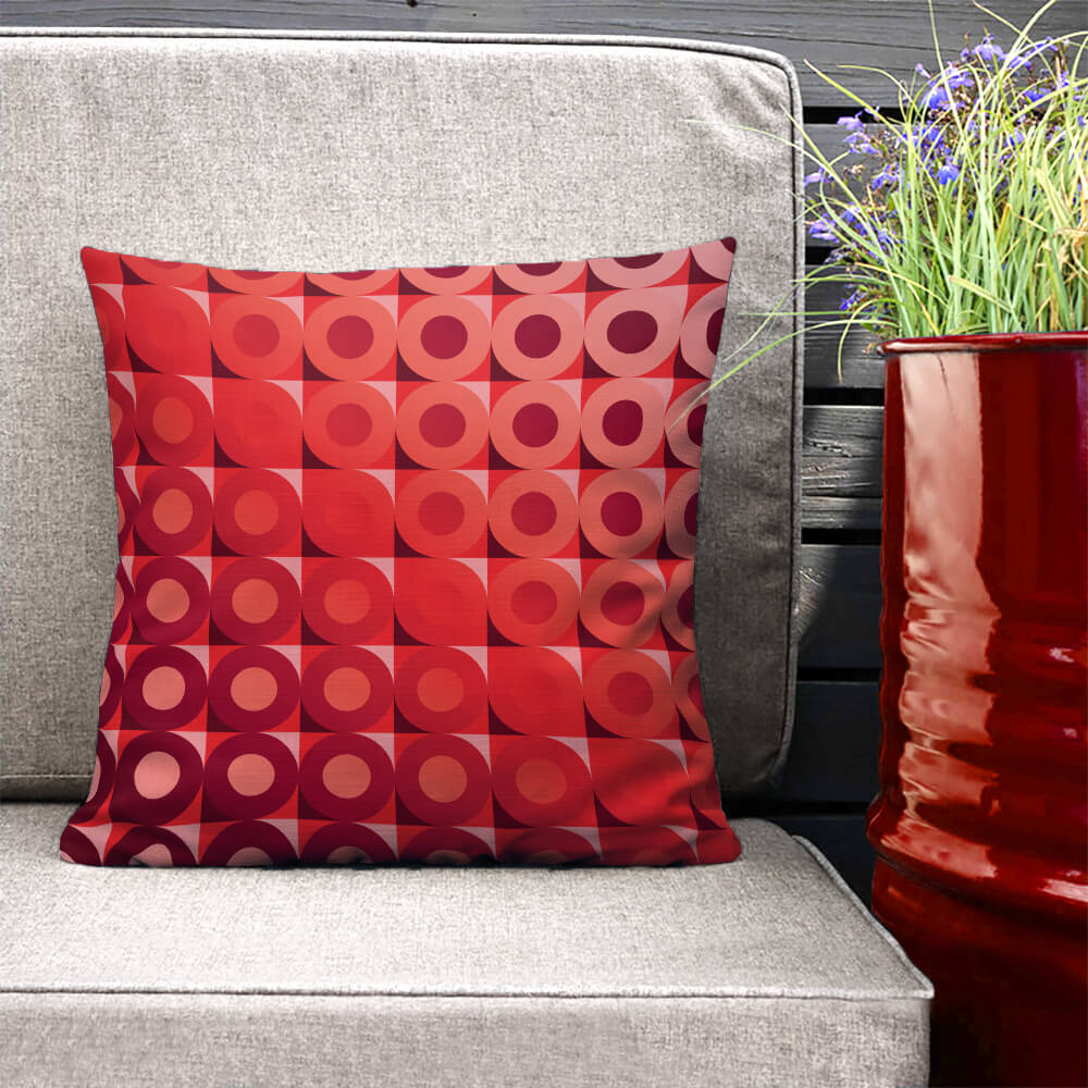 Mid Century Modern Coral Red LifeSavers 18" Square Throw Pillow on a patio bench