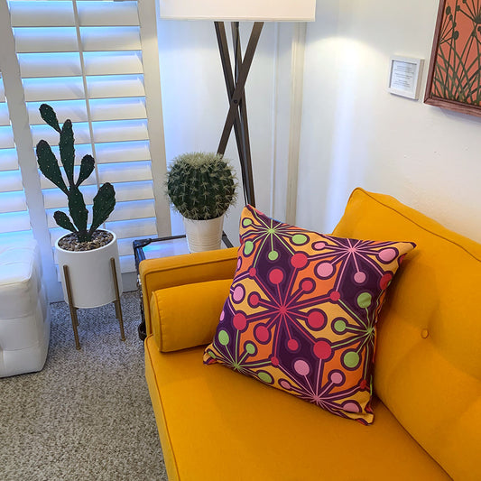 Mid Century Modern Multicolour PsychoFlakes 22" Square Throw Pillow on orange sofa