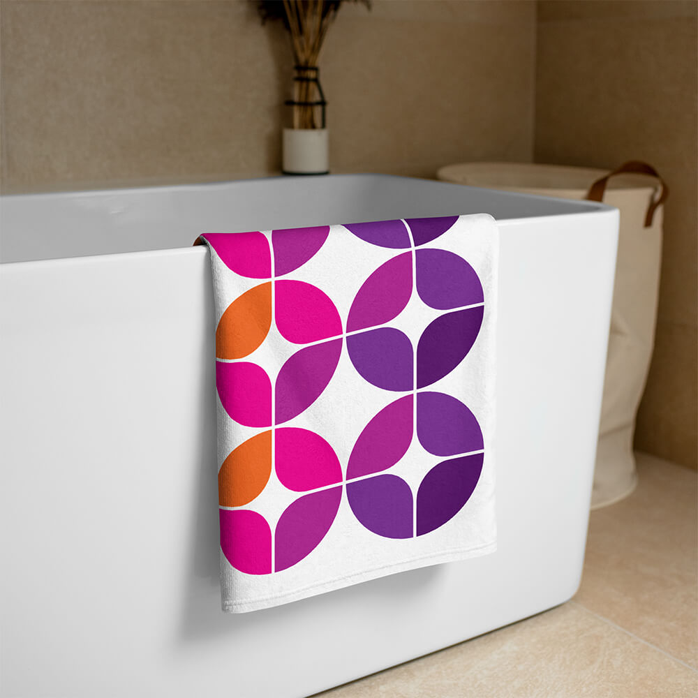 Mid Century Modern Purple Orange StarChips Beach & Pool Towel on a bathtub