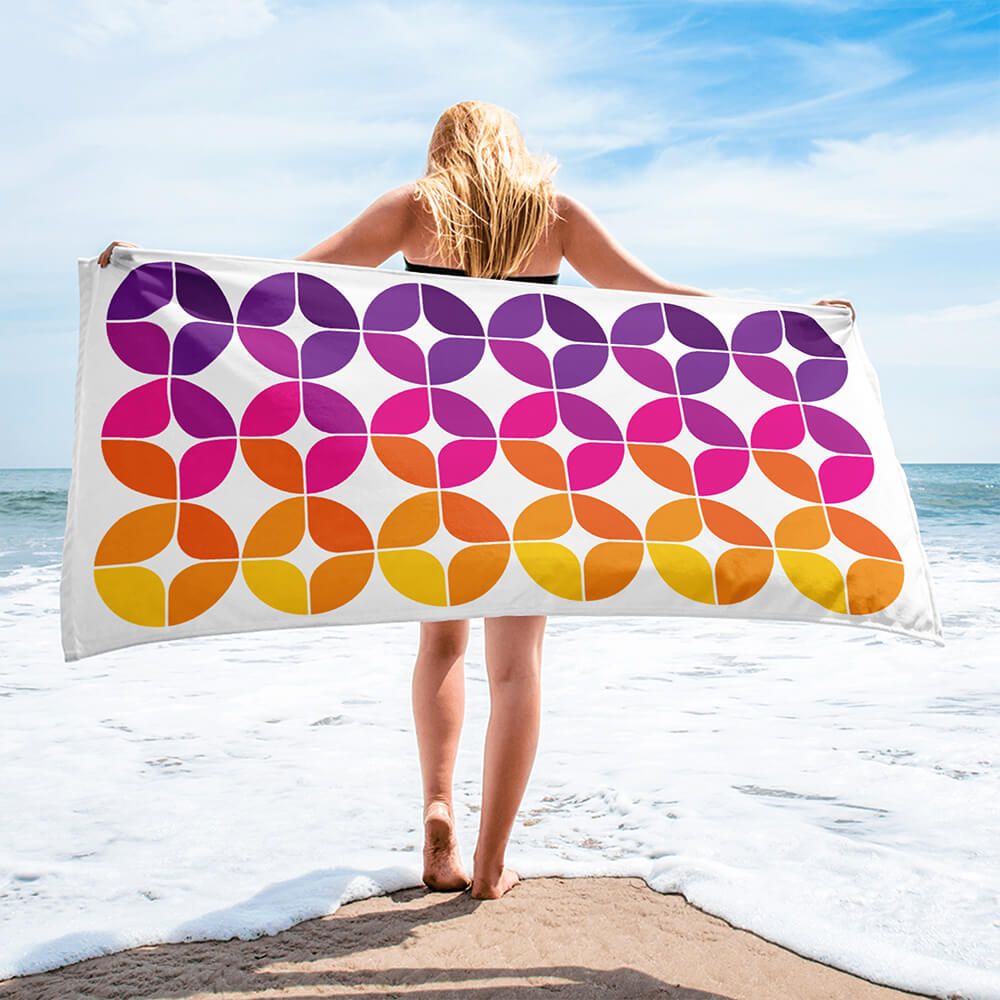 Mid Century Modern Purple Orange StarChips Beach & Pool Towel held by a girl at the beach