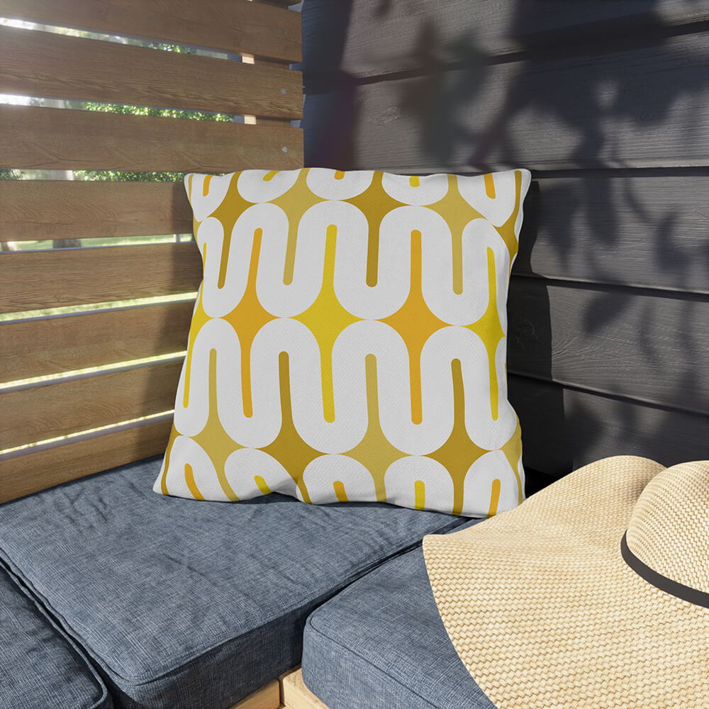 Mid Century Modern Yellow Galaxie 18" Outdoor Pillow on a corner bench