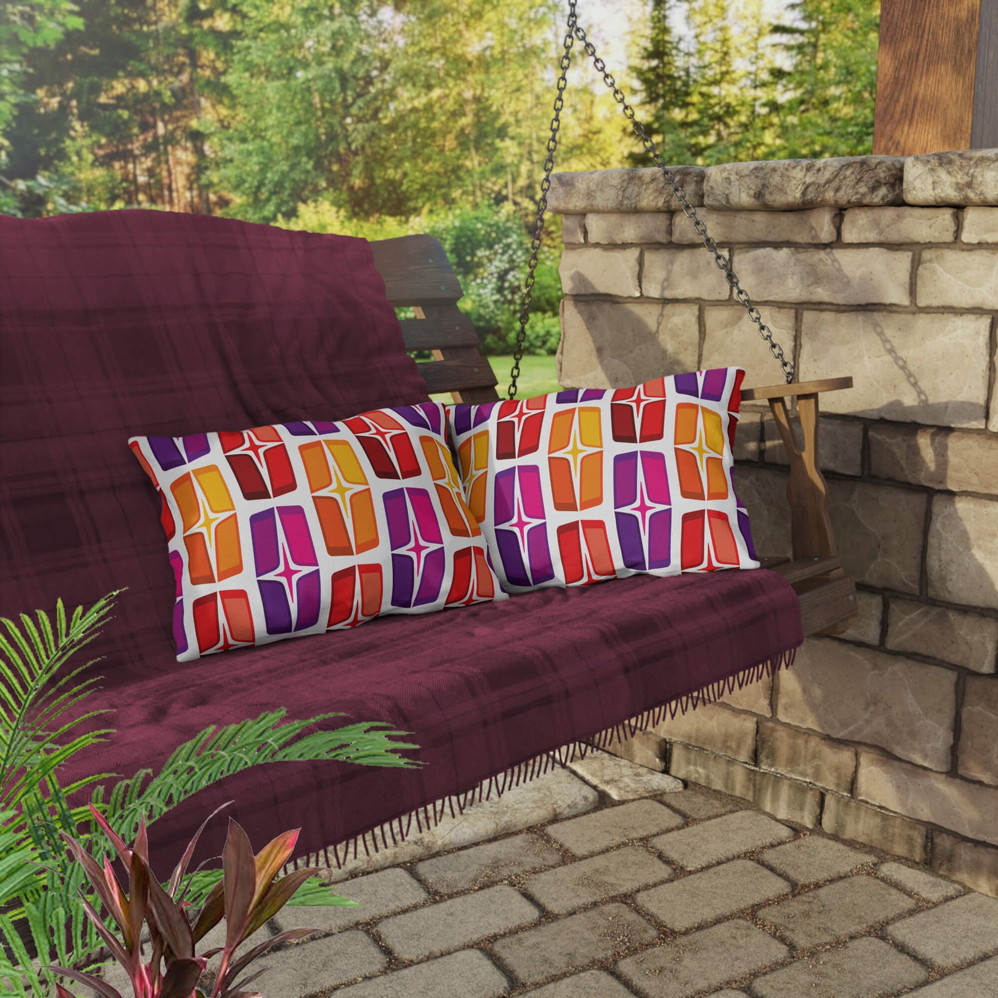 Mid Century Modern Orange Purple AstroShields 20" x 14" Rectangular Outdoor Pillow on a swing bench
