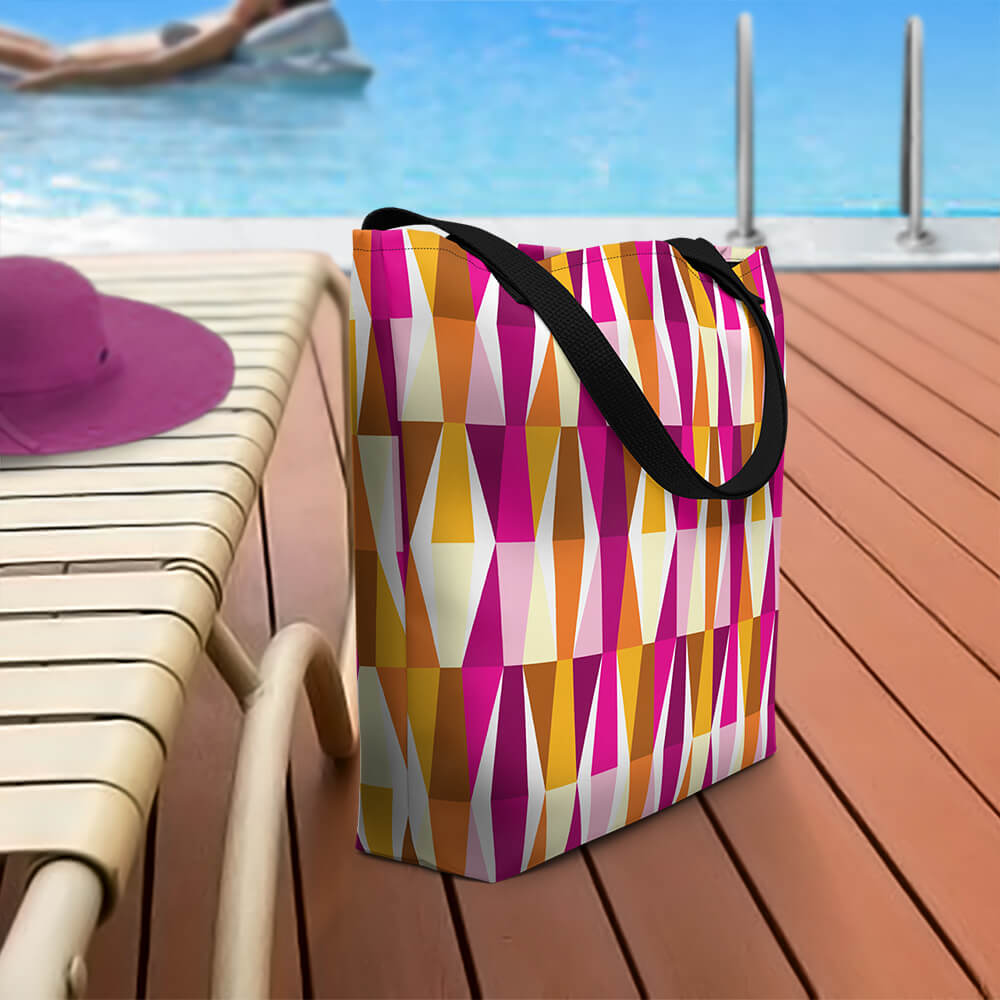 Mid Century Modern Orange Pink LozAnges Beach Bag on a pool deck