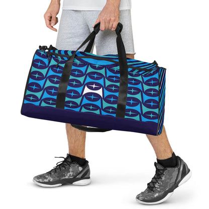 Mid Century Modern Blue Aqua Mid-Mod Star Duffle Bag carried by handles by a man