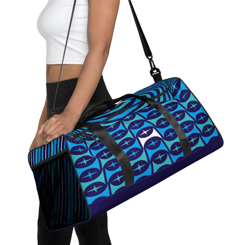 Mid Century Modern Blue Aqua Mid-Mod Star Duffle Bag carried by shoulder strap by a girl