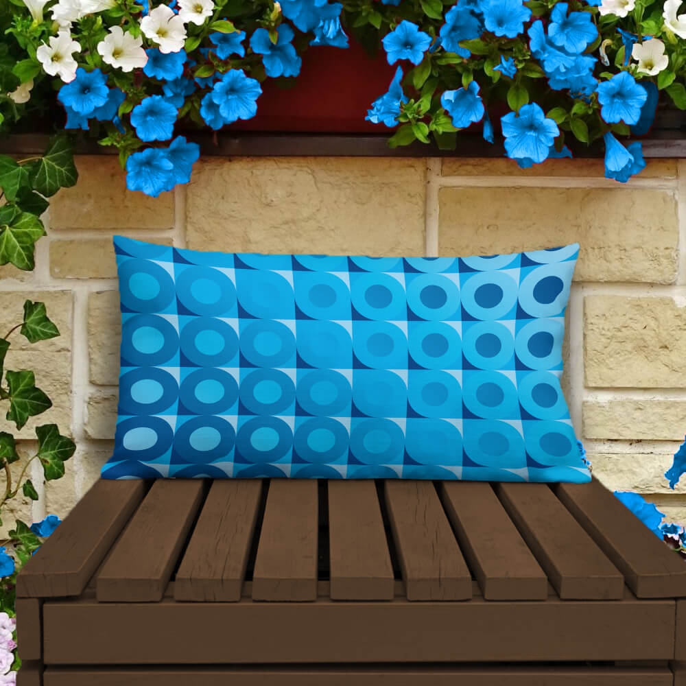 Mid-century Modern Blue LifeSavers 20" x 12" Rectangular Throw Pillow on a patio bench